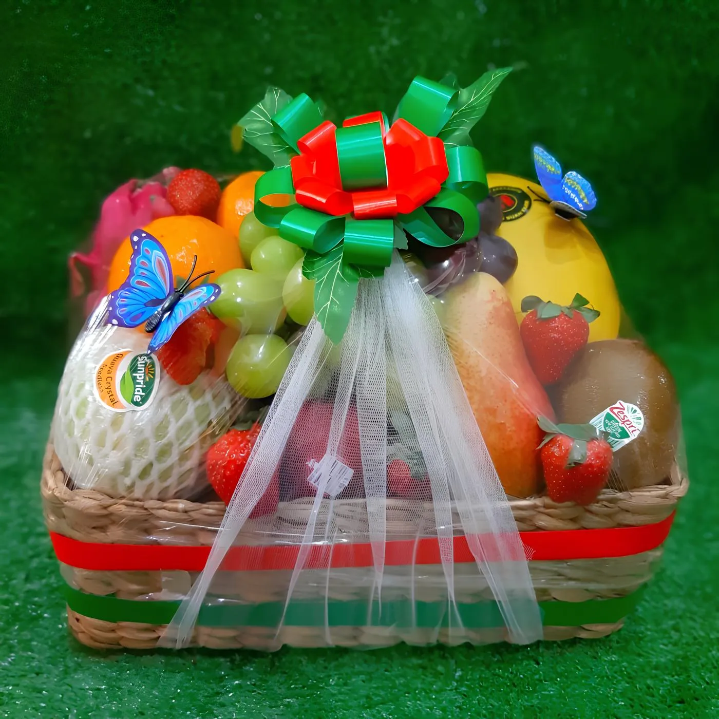 Eid fruit hampers with mangoes, dates, oranges, and apples wrapped in custom-printed textile packaging.
