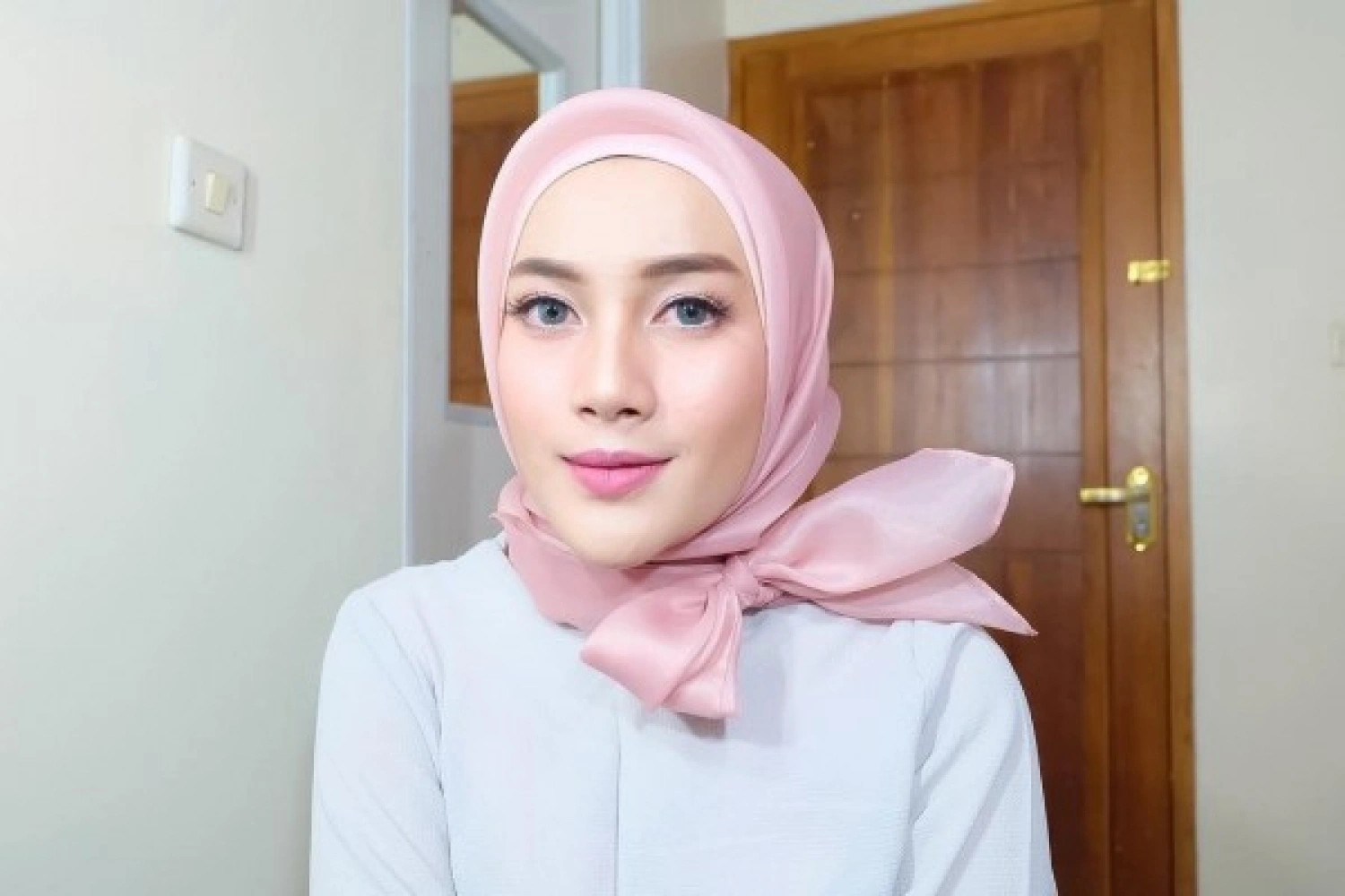 Organza hijab style with sheer, glossy fabric popular among youth for formal and elegant looks.