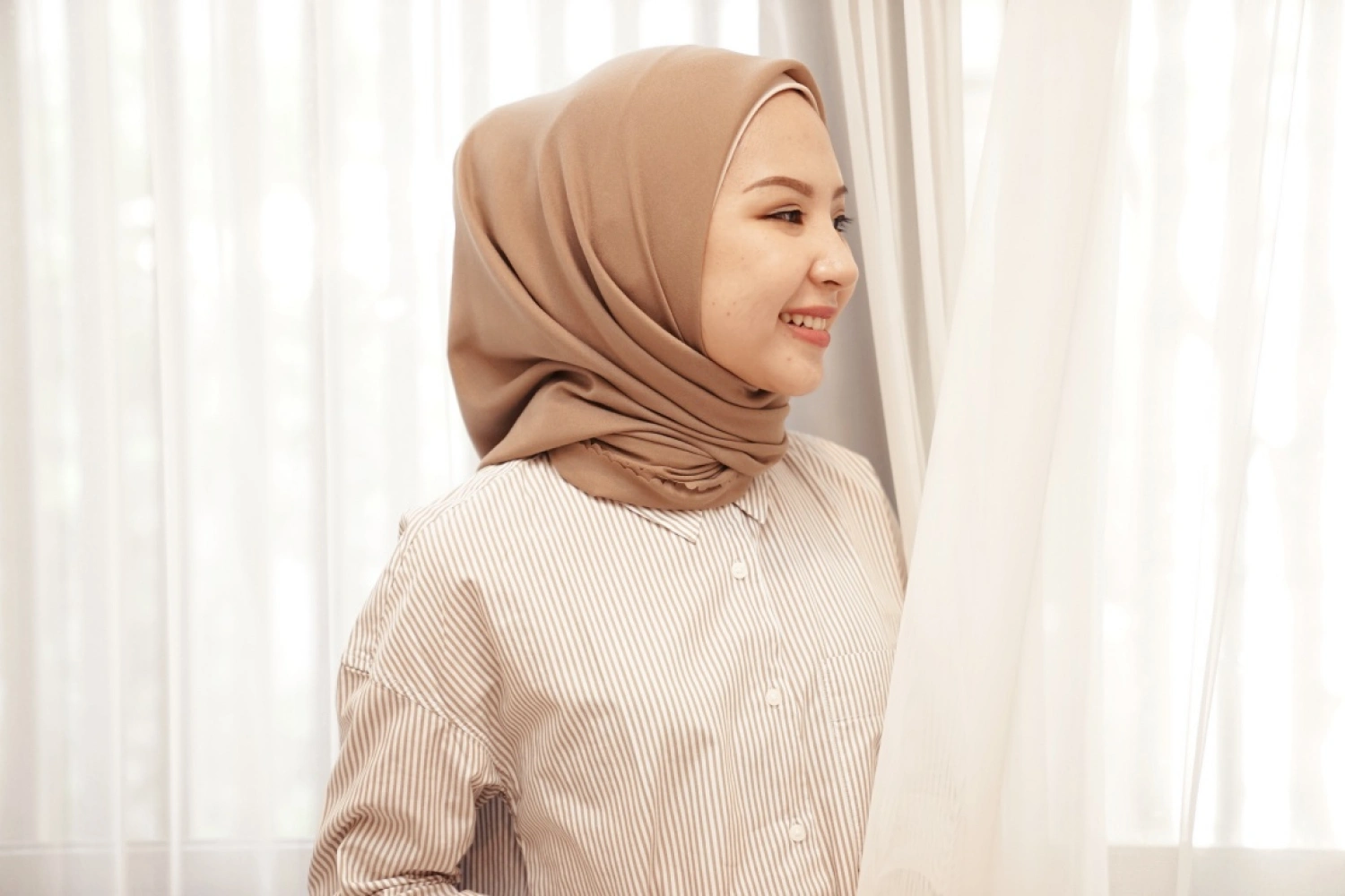 "Square hijab style favored by youth for its timeless shape, easy styling, and adaptable fabric choices.