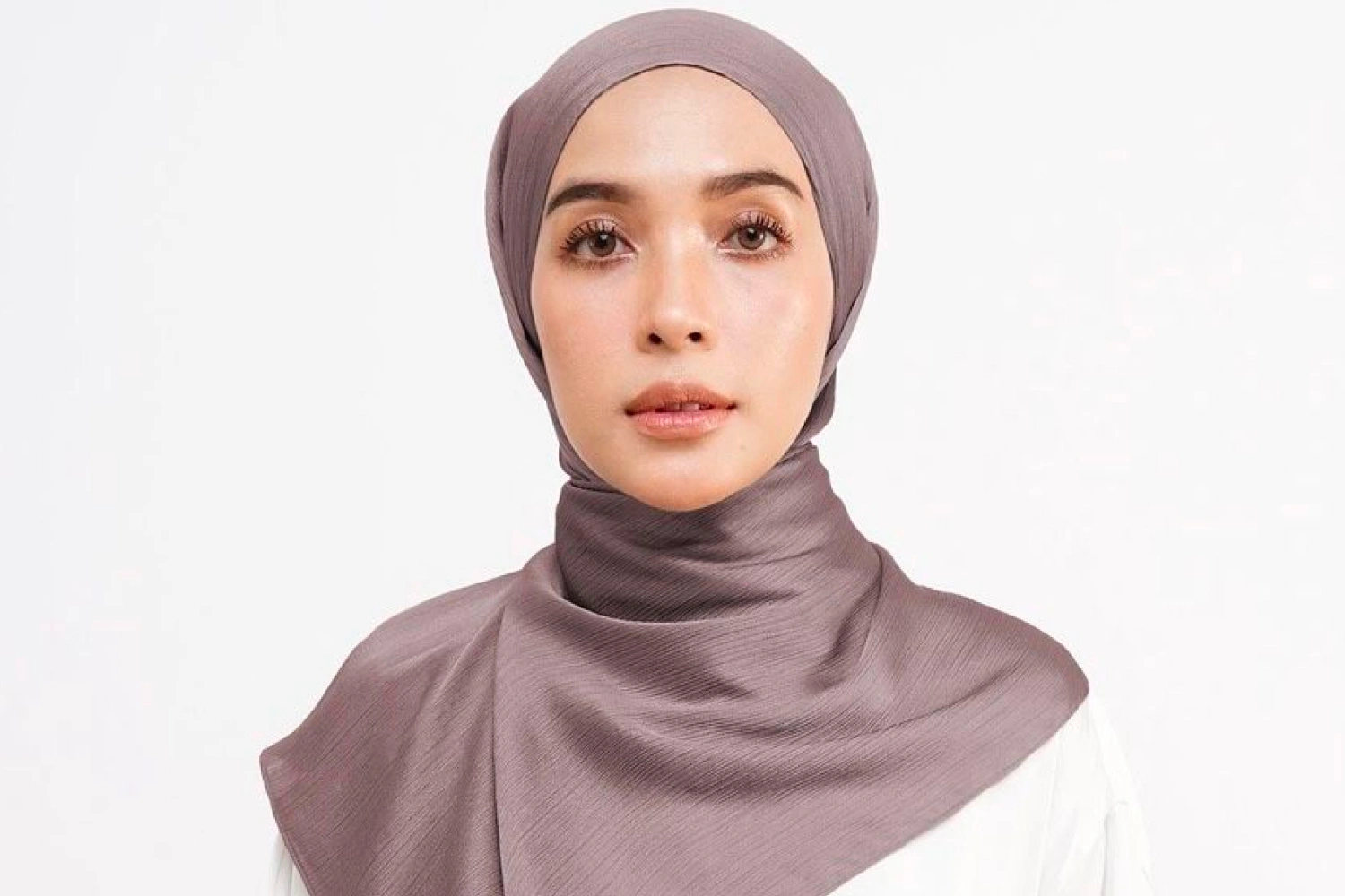 Silk hijab style popular among youth for its smooth texture, elegant drape, and luxurious fashion appeal.