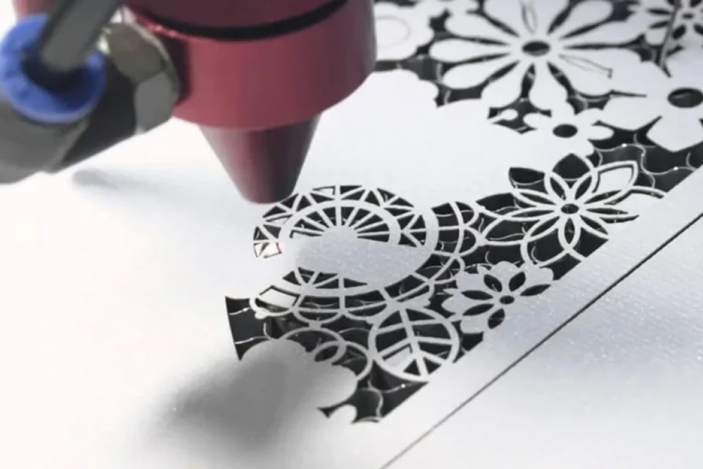 Laser cutting machine engraving intricate designs or logos onto fabric, offering precision for marking and customization