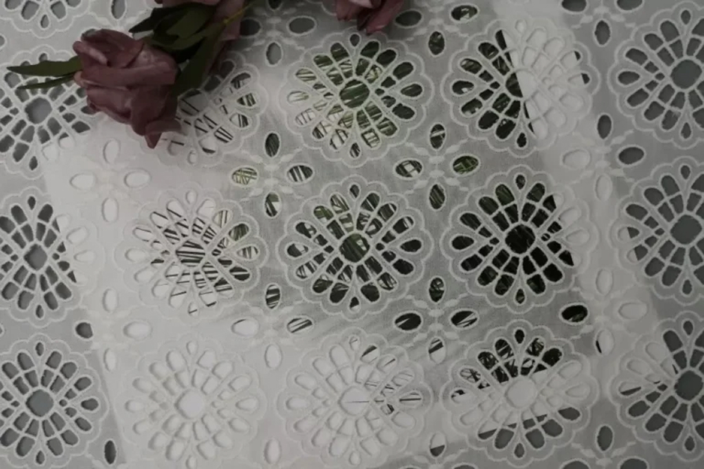 Laser machine cutting intricate and complex patterns into fabric with precision, ideal for detailed fashion and textile designs