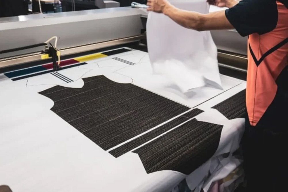Laser cutting technology minimizing fabric waste by optimizing pattern placement, reducing the need for manual cutting and excess material use