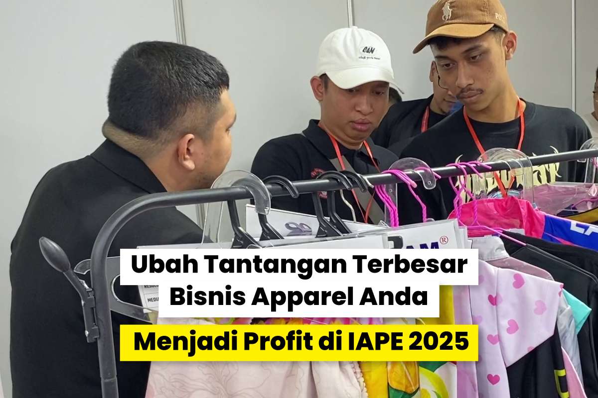 tiga orang sedang berdiskusi di booth pameran apparel IAPE 2025 sambil melihat contoh pakaian