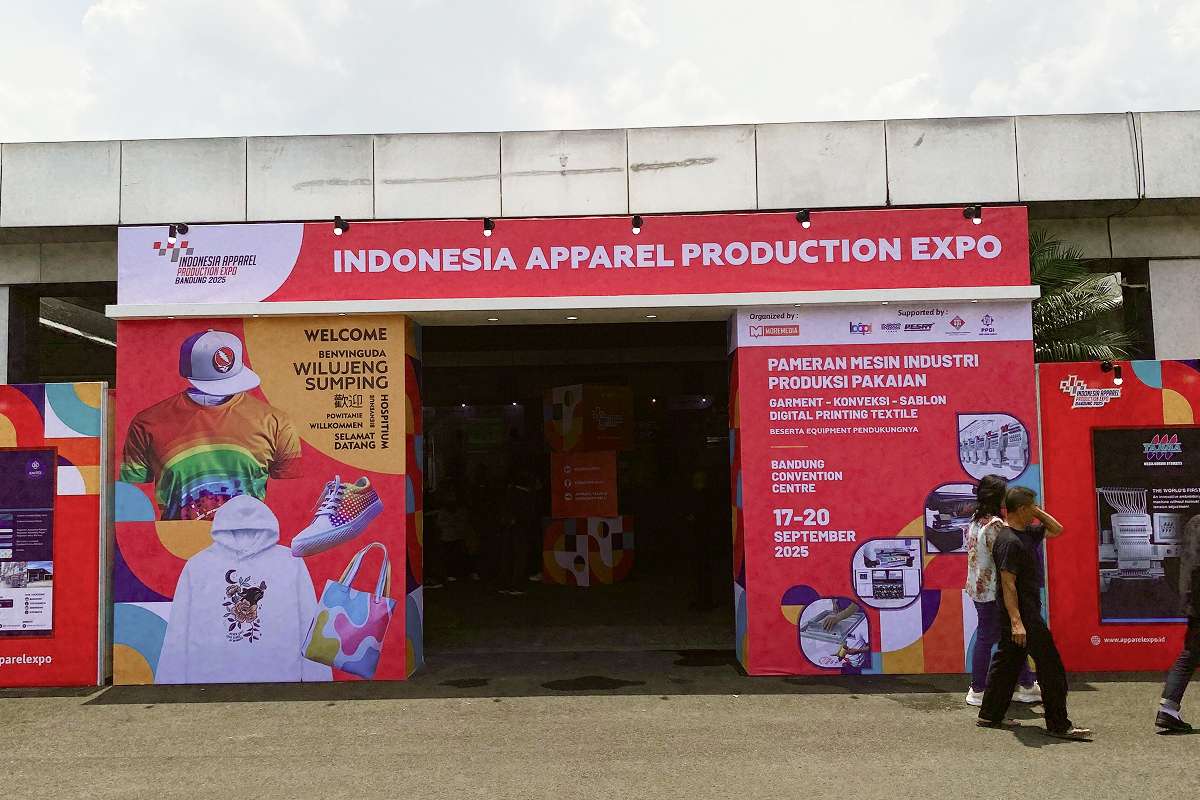 Entrance of Indonesia Apparel Production Expo with a large banner of IAPE Bandung 2025.
