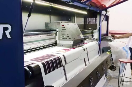 A promotional photo of a sublimation and DTF printer with a heat press machine in operation