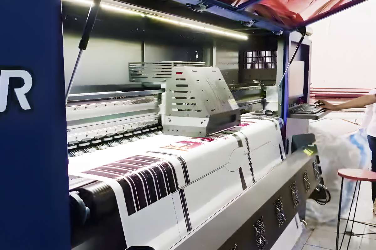 A promotional photo of a sublimation and DTF printer with a heat press machine in operation