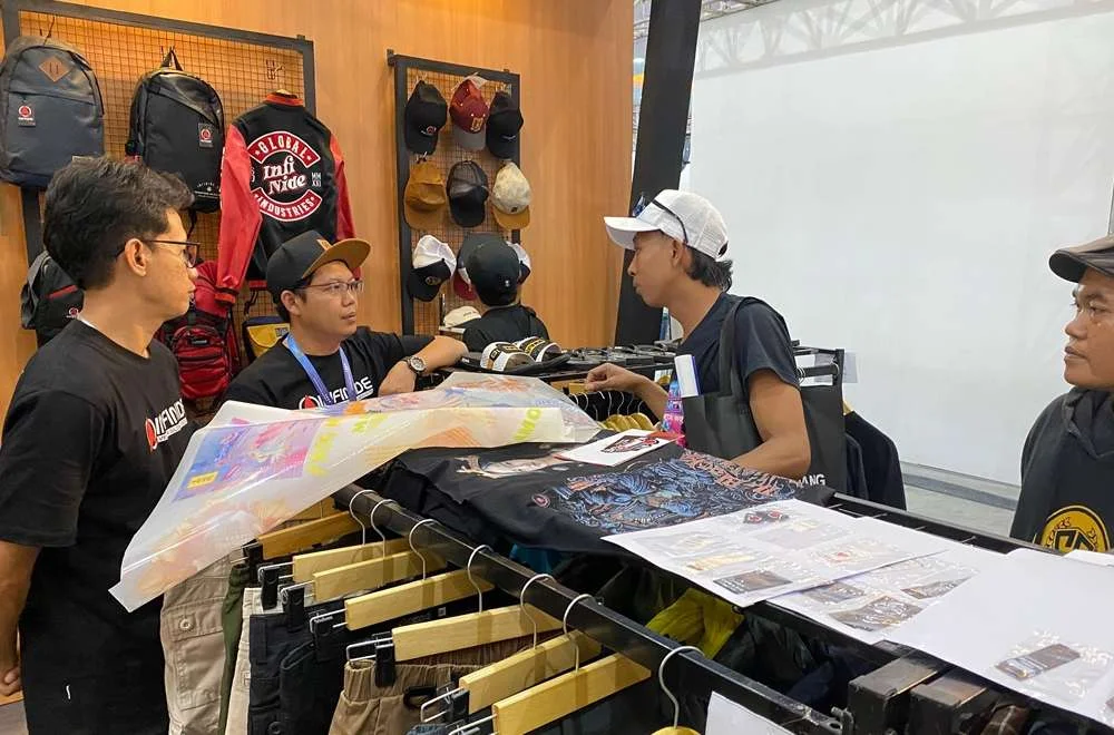 Pengunjung berdiskusi di booth apparel custom saat mengenal suasana dan keunggulan kenduri sablon jogja 2026.